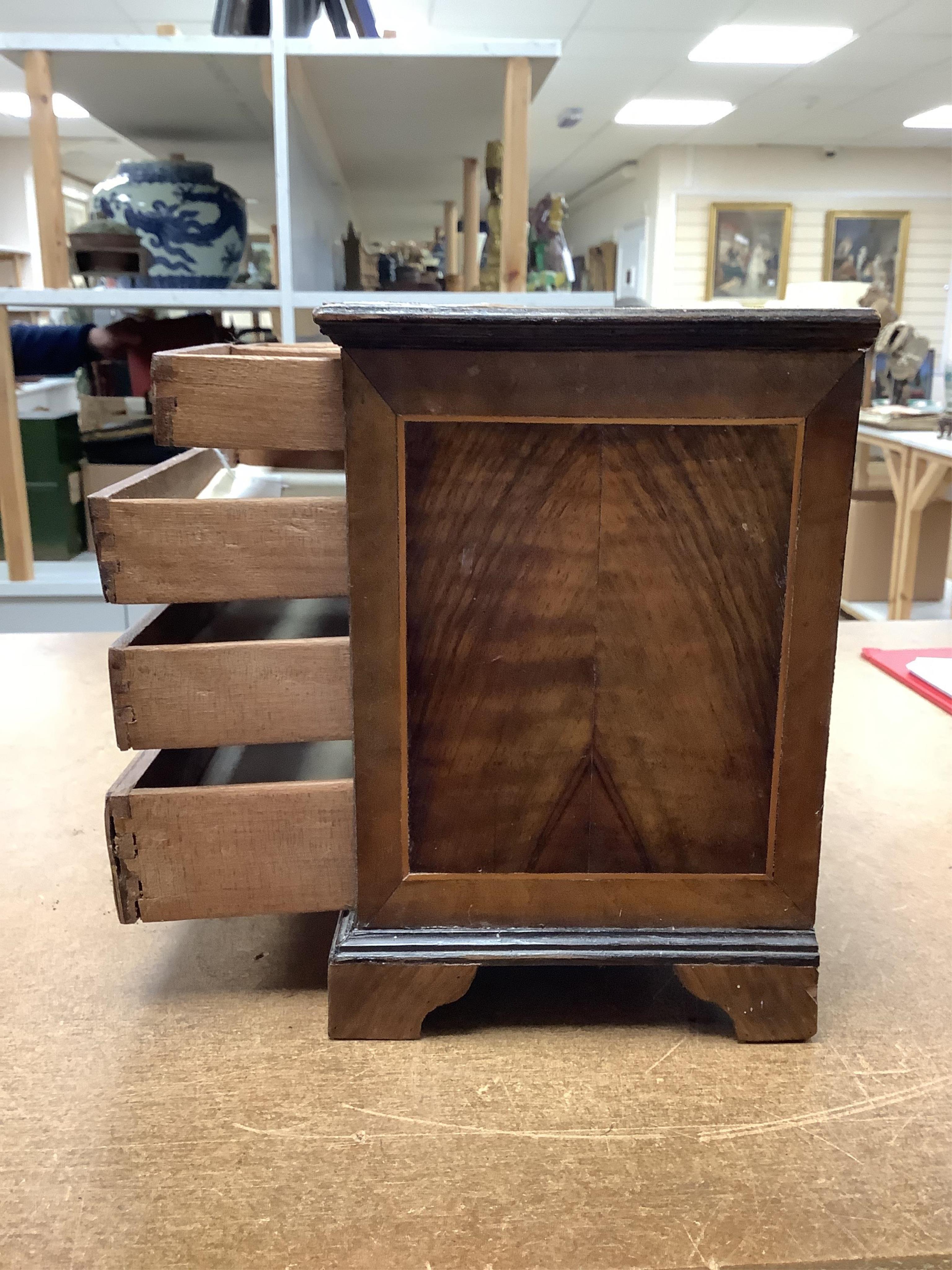 A miniature three long and two short inlaid chest of drawers, 21.5cm high x 23.5cm wide. Condition - poor to fair